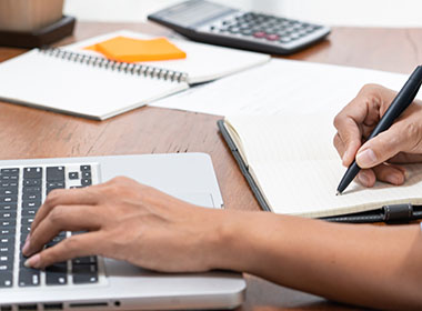 close-up-of-student-learning-online-class-by-using-laptop-computer-and-writing-notebook-at-workplace-e-learning-and-online-working-concept